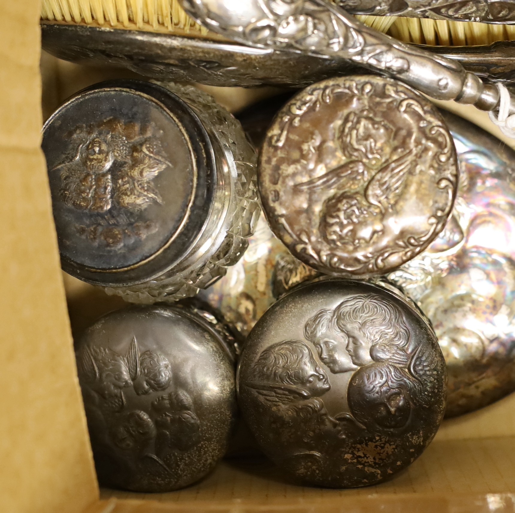 A late Victorian five piece silver Reynolds angel dressing table set, maker William Comyns, four assorted silver lidded glass Reynolds angel toilet jars and sundries